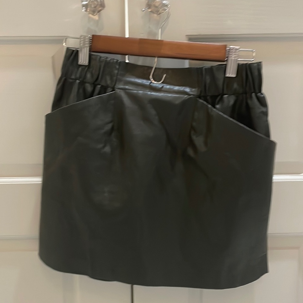 Faux leather army green skirt.  It has wide elastic band with pockets.
